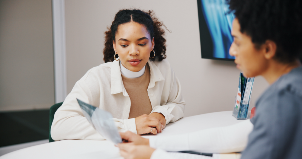 A SkinCure practitioner discussing skin assessment results with a client during a consultation