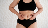 front view of woman touching her belly