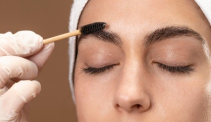 close-up of a woman having eyebrow waxing
